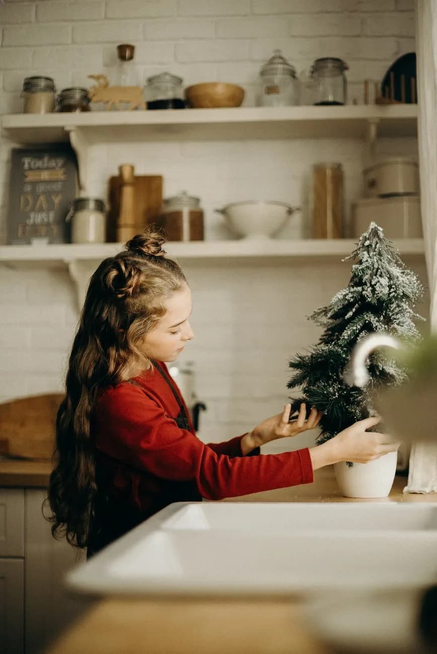 little girl checking on a christmas tree