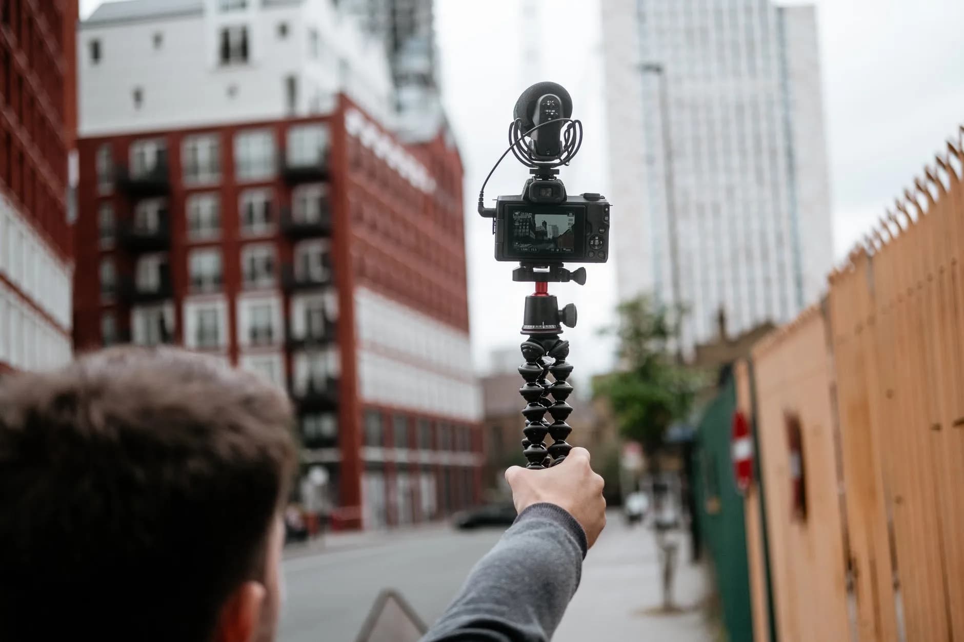 young correspondent recording video of city