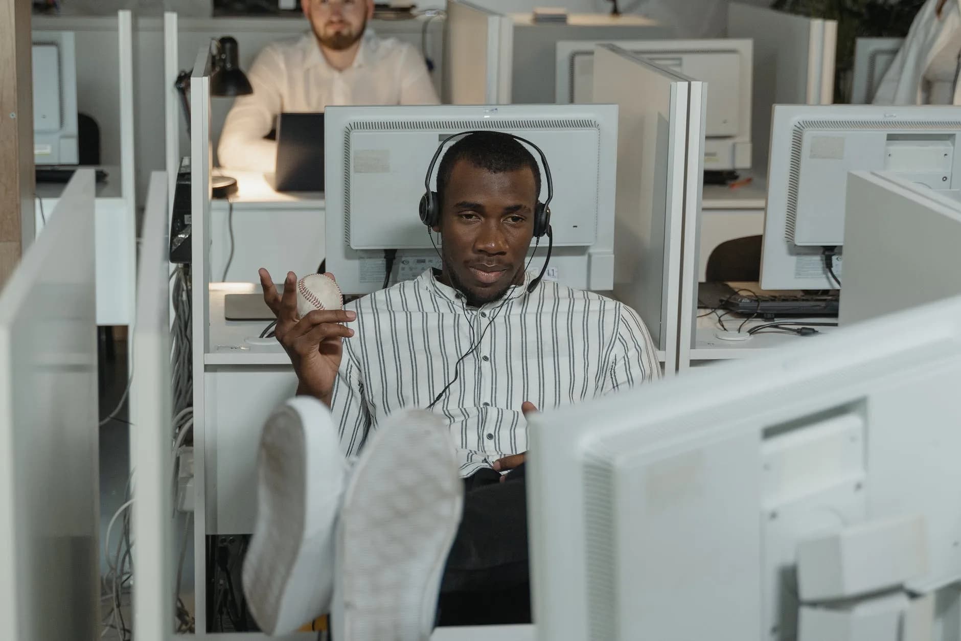 man wearing headphones while working in call center office