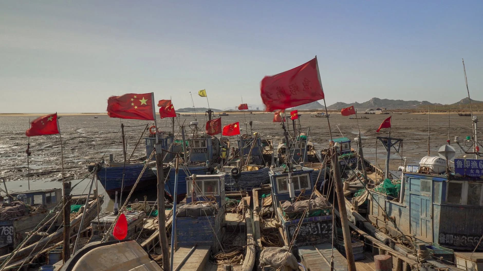 red flags on wooden boats