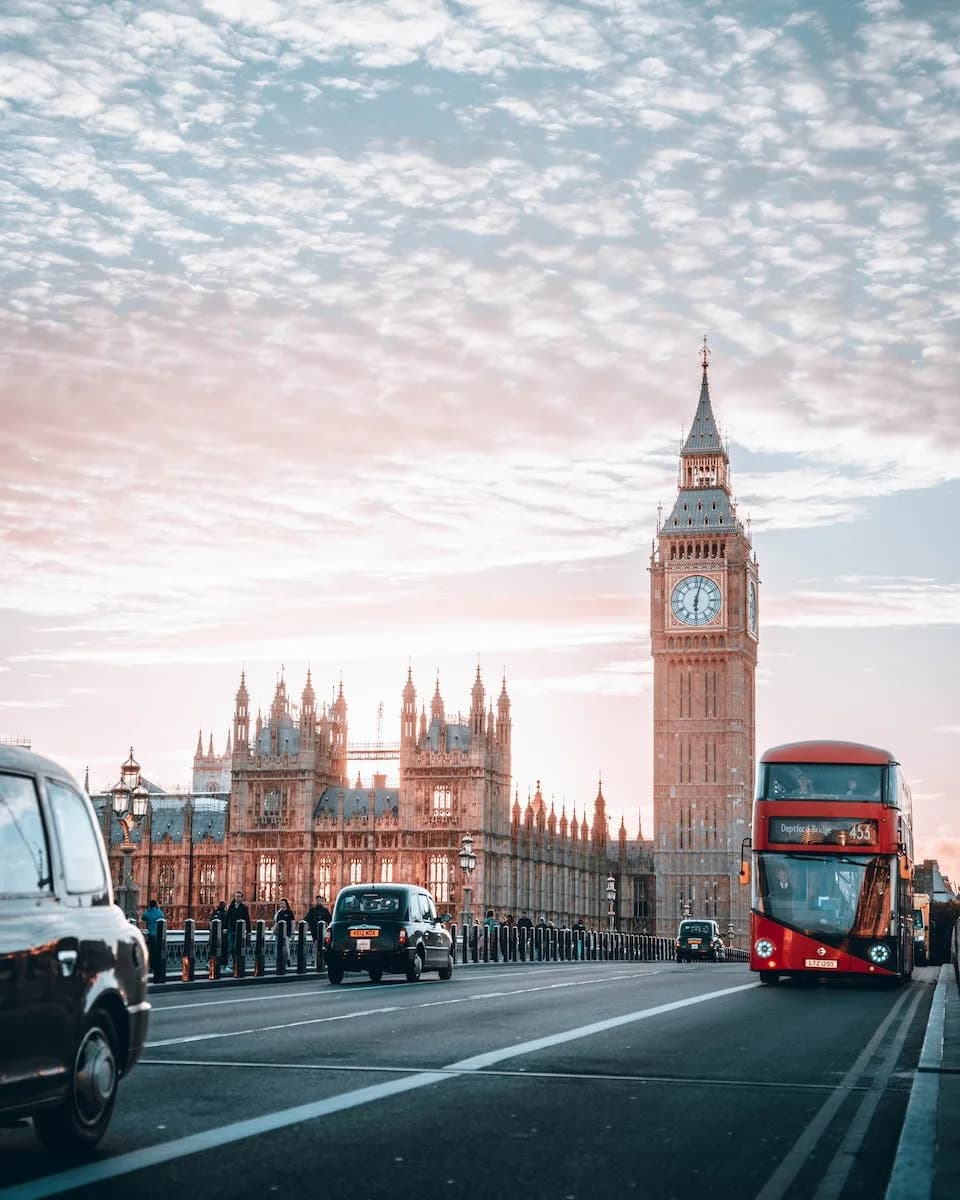 Red Bus with multiple taxis in front of Big Ben london